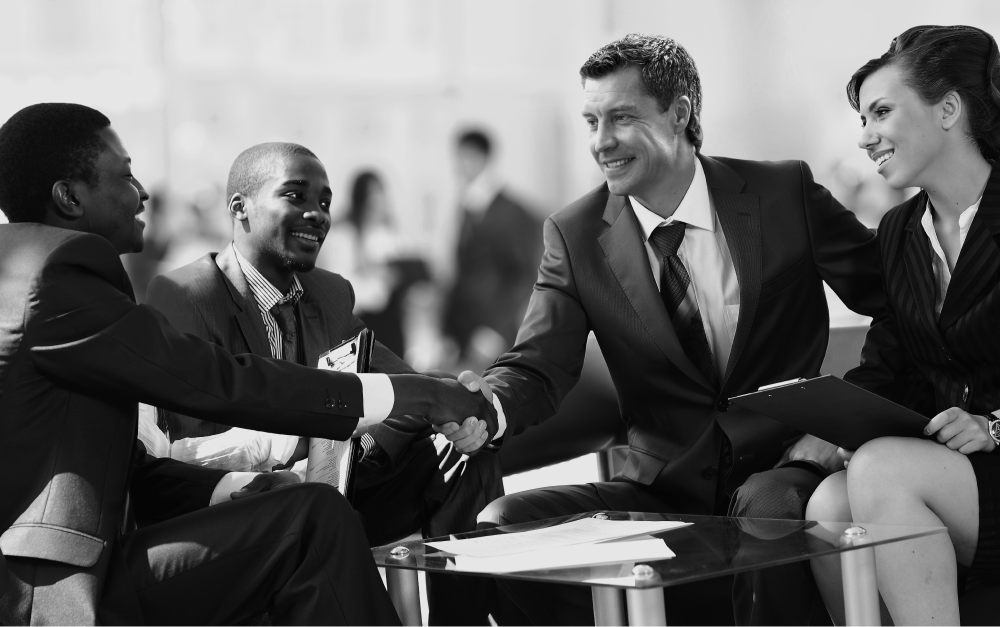 Photo en noir et blanc. Un homme serre la main d'une autre personne.